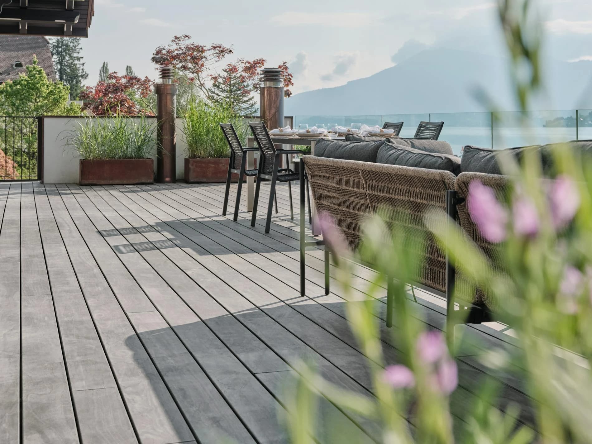 Rooftop deck in Accoya Color Grey with outdoor lounge, facing a lake and mountains